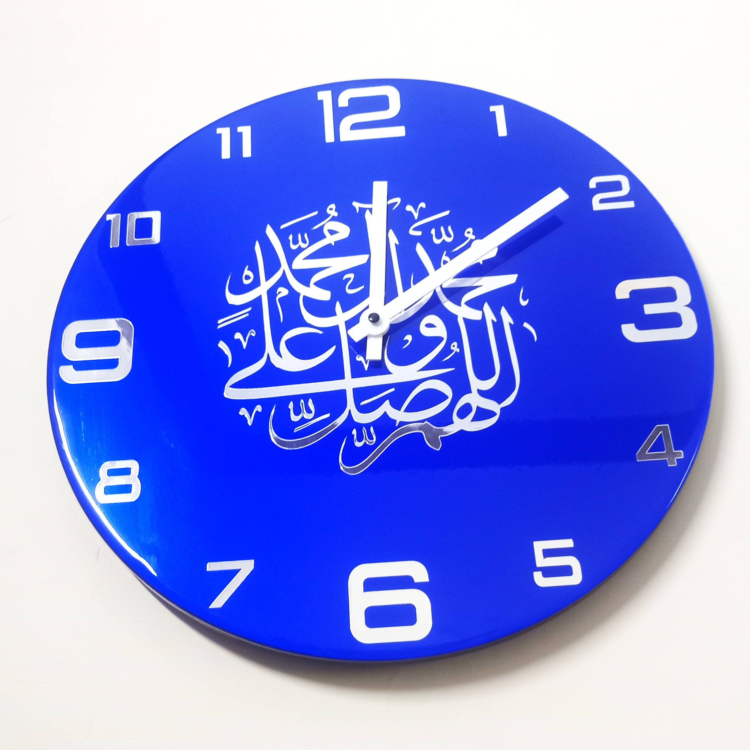 Handmade blue round wall clock featuring elegant white Arabic calligraphy in the center.